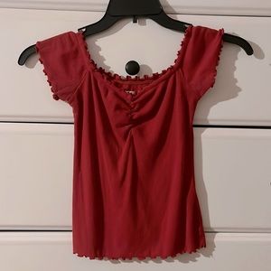 A red tee and can be worn either off the shoulder or on. Soft and slightly used
